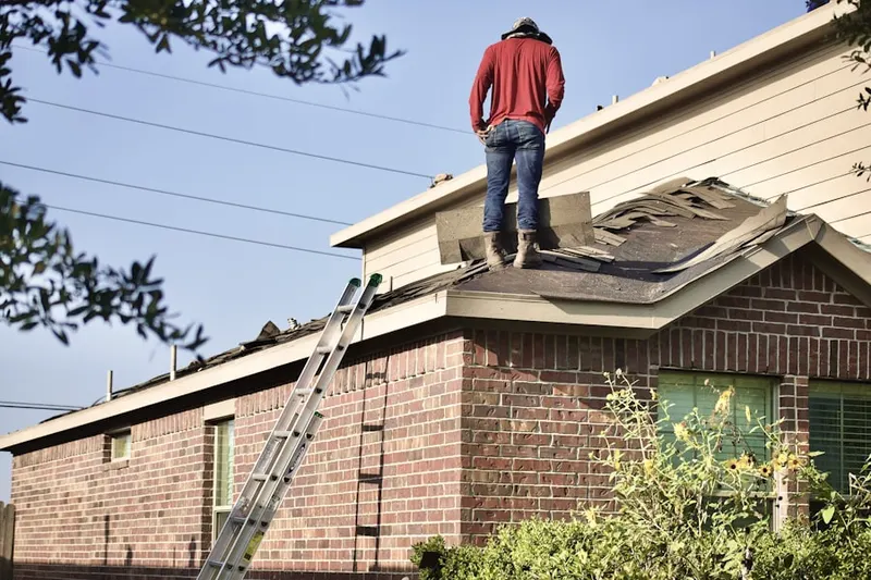 Professional roofer working on a residential roof in North Kansas City